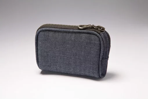 Denim insulin pump case clipped to belt with zipper closed
